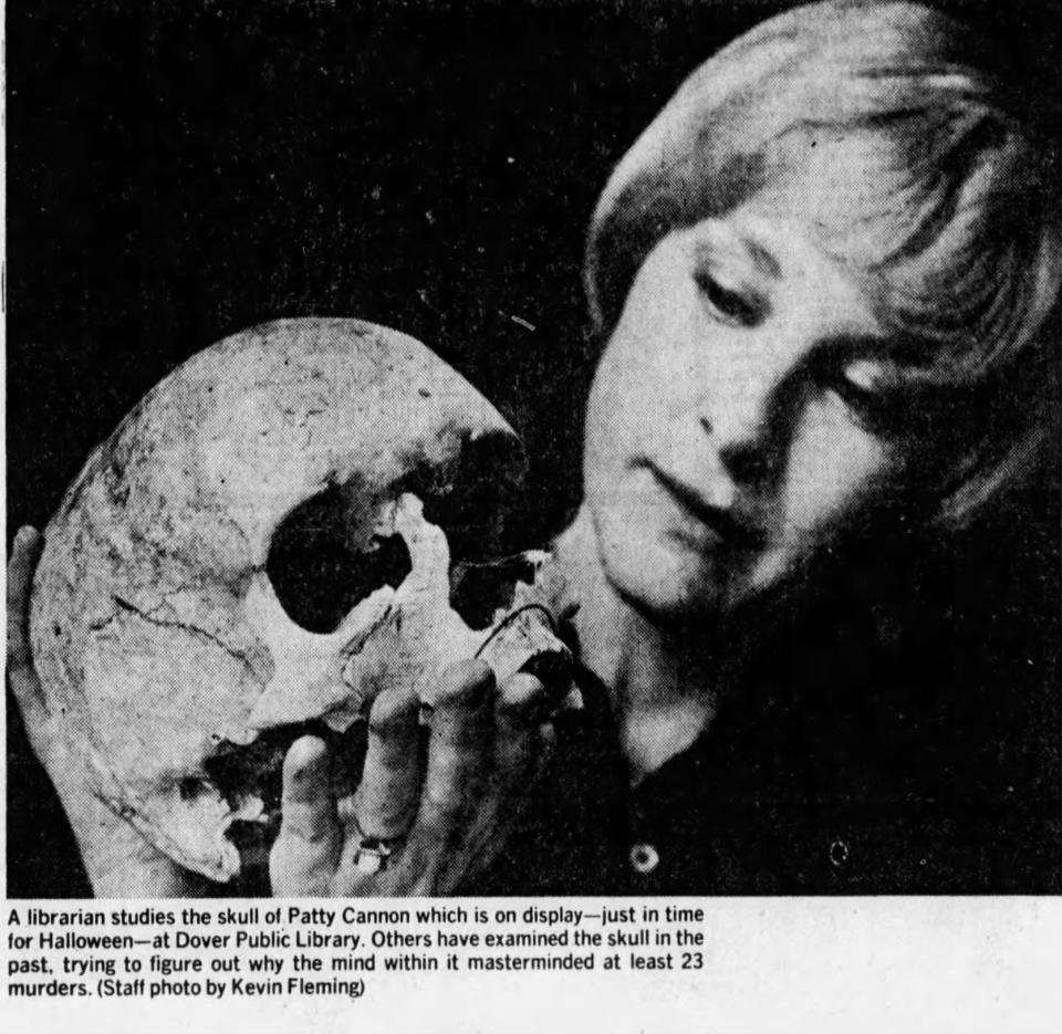 A 1978 News Journal photo of a librarian holding the reputed skull of 19th-century killer Patty Cannon. The skull was occasionally displayed at Halloween at the Dover Public Library until 2004. It was later loaned to the Smithsonian National Museum of Natural History.