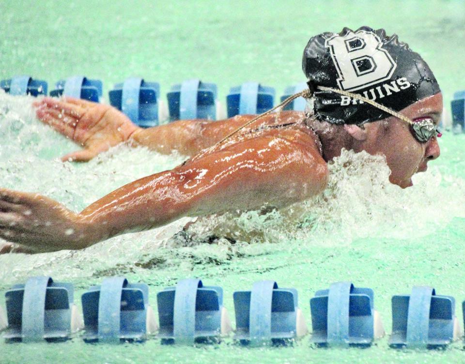 June Harris bursts through the water during her swimming career in the late 2010's at Bartlesville High.