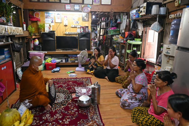 Family members of Sithu, 37, who was killed during a raid by security forces pray at their home in Thaketa, Yangon