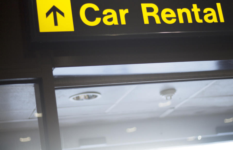 Car rental sign pointing up