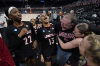 Louisville forward Liz Dixon (22), guard Merissah Russell (13), and center Josie Williams, right, celebrate with fans after the team's win over Texas in a second-round college basketball game in the NCAA Tournament in Austin, Texas, Monday, March 20, 2023. (AP Photo/Eric Gay)