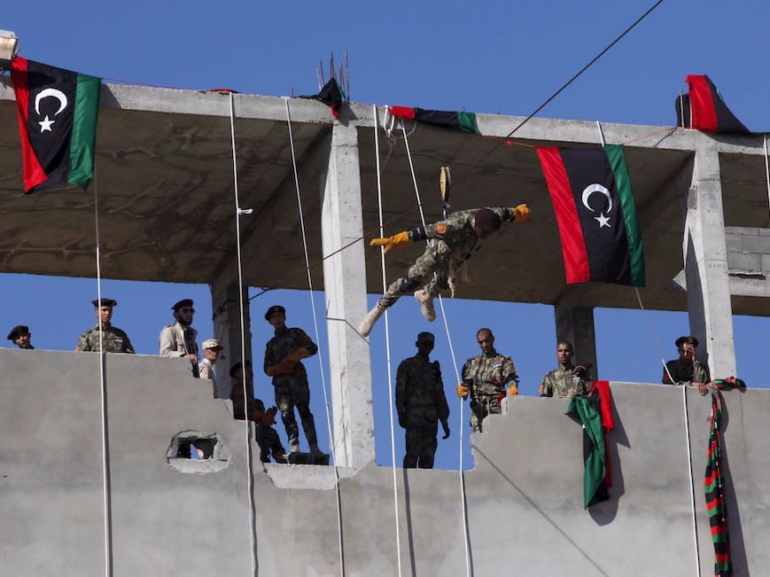 A Libyan Army soldier demonstrates his skill during a military graduation parade in Tripoli December 24, 2015.