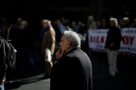 A Greek pensioner smokes during a demonstration against cutbacks in medical care in Athens, Greece, November 23, 2017. REUTERS/Alkis Konstantinidis