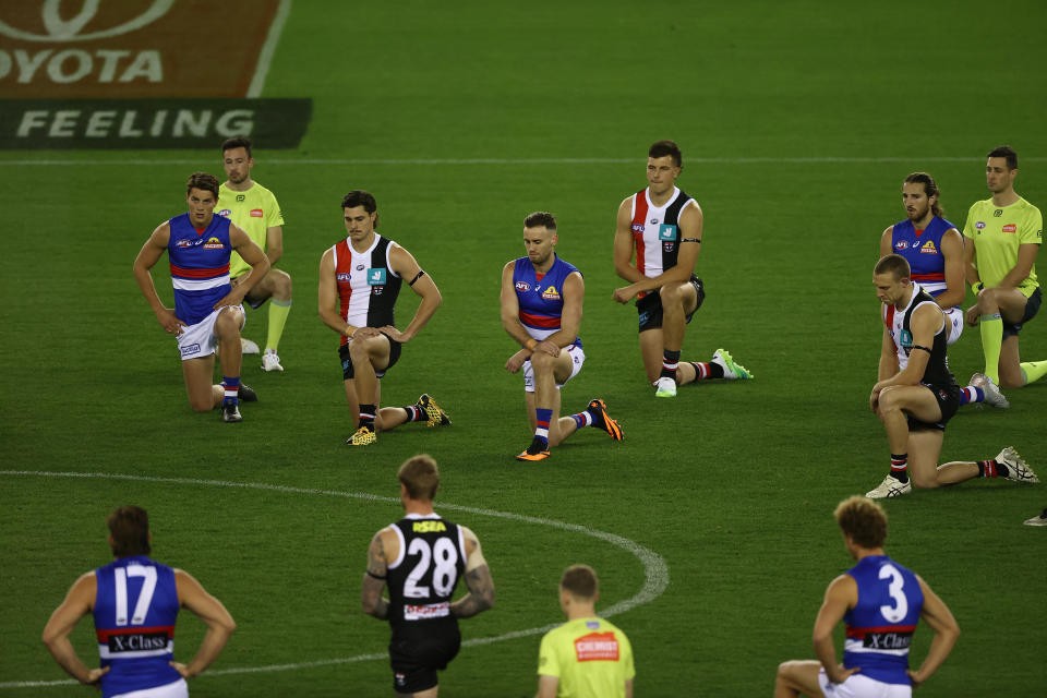 Players kneel during the round 3 AFL match between the St Kilda Saints and the Western Bulldogs.