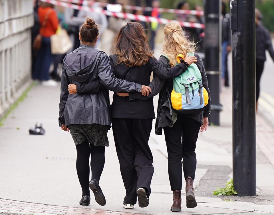 People arrive to pay their respects at the scene (James Manning/PA)