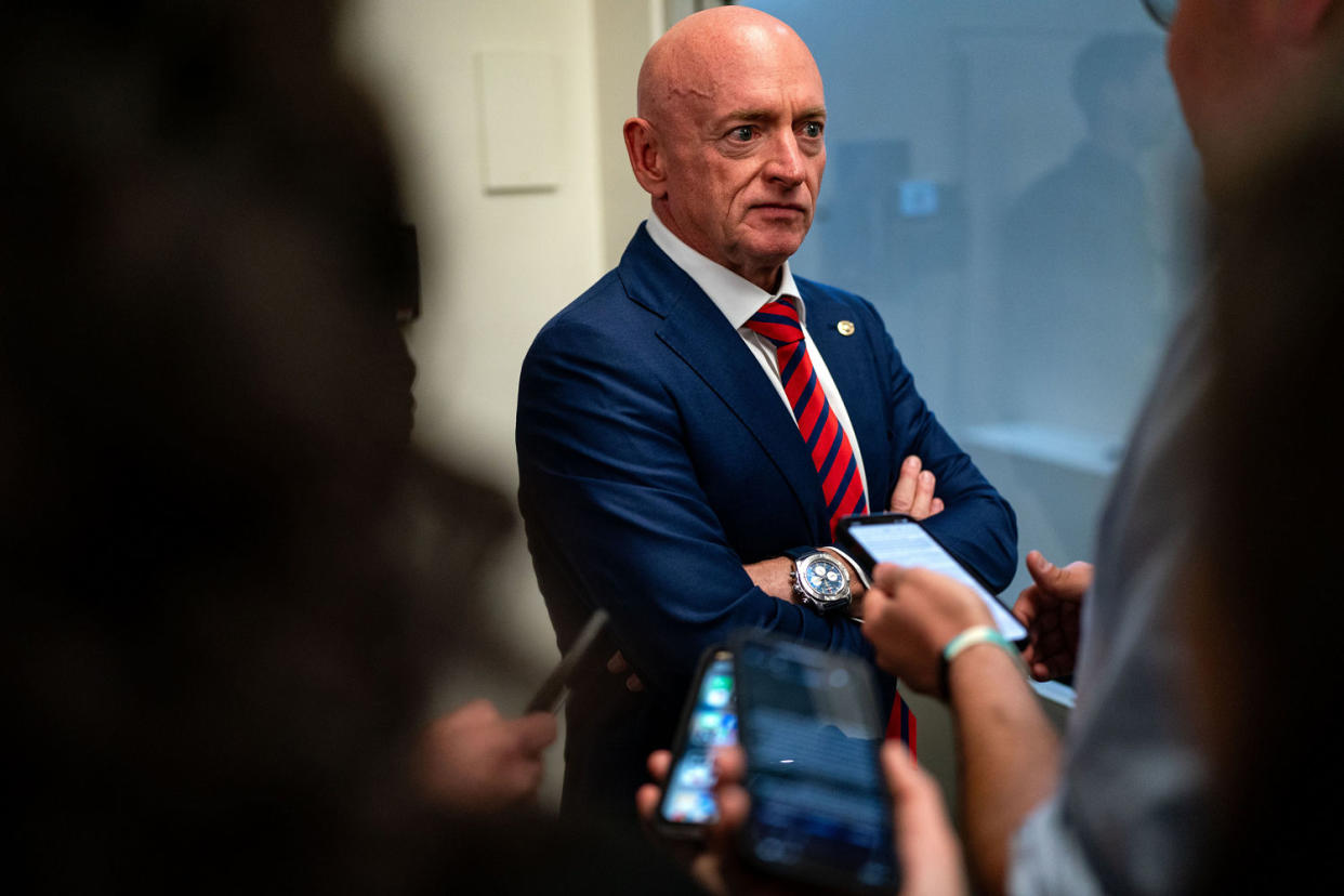 Mark Kelly speaks with reporters while waiting to catch the Senate subway to the Hart Senate Office Building from the U.S. Capitol (Kent Nishimura / Getty Images)