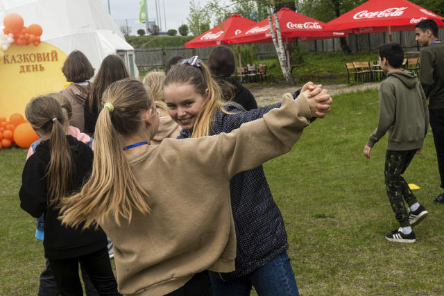Olha Hinkina dances with her friend at the recovery camp for children and their mothers affected by the war near Lviv, Ukraine, Wednesday, May 3, 2023. A generation of Ukrainian children have seen their lives upended by Russia's invasion of their country. Hundreds of kids have been killed. For the survivors, the wide-ranging trauma is certain to leave psychological scars that will follow them into adolescence and adulthood. UNICEF says an estimated 1.5 million Ukrainian children are at risk of mental health issues. (AP Photo/Hanna Arhirova)