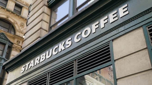 A Starbucks Coffee sign is shown on a building.