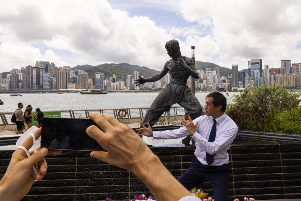 Fans gather in front of the statue of martial artist Bruce Lee to commemorate the 50th anniversary of his death in Hong Kong, Thursday, July 20, 2023. (AP Photo/Louise Delmotte)