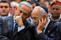 <p>Israeli Prime Minister Benjamin Netanyahu (L) chats with Israeli President Shimon Peres during a ceremony marking Remembrance Day for the fallen soldiers on Mount Herzl Military Cemetery, in Jerusalem on April 15, 2013. (REUTERS/Jim Hollander/) </p>