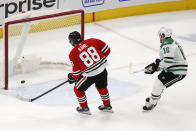 Chicago Blackhawks right wing Patrick Kane (88) scores an empty net goal as Dallas Stars center Joe Pavelski (16) looks on during the third period of an NHL hockey game Tuesday, April 6, 2021, in Chicago. The Blackhawks won the game 4-2. (AP Photo/Jeff Haynes)