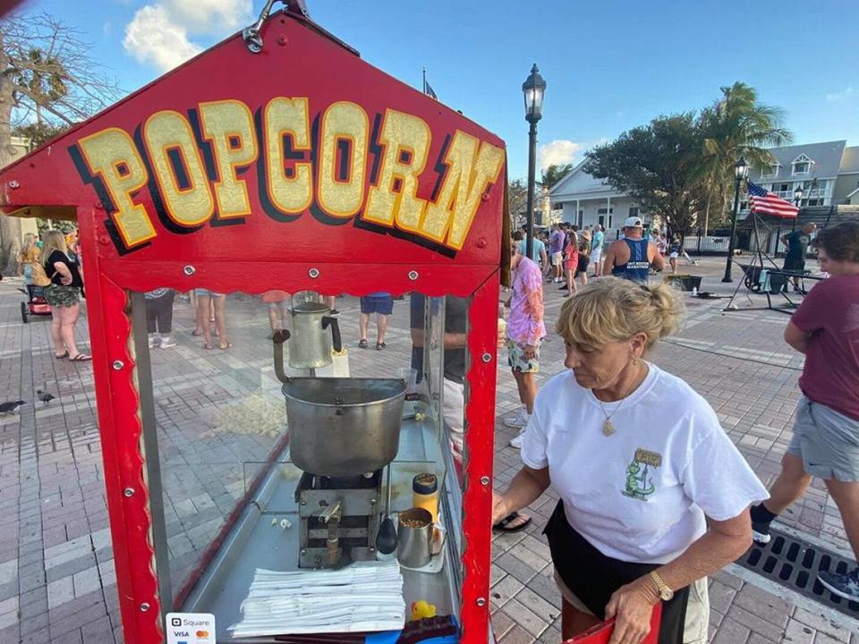 Clara Taylor works her popcorn concession at Mallory Square on March 16, 2020.