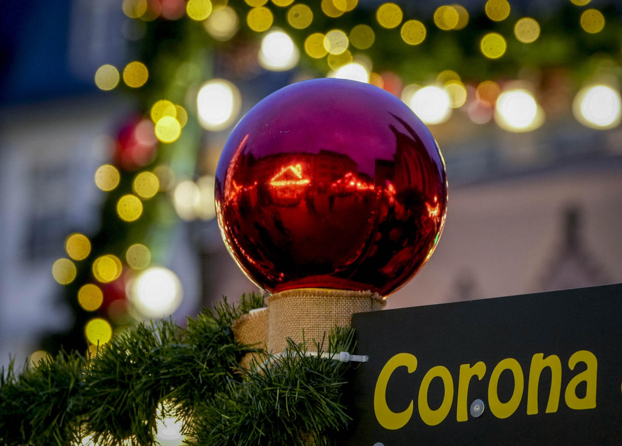 FILE - The word "Corona" at the Christmas market in central Frankfurt, Germany, Tuesday, Nov. 23, 2021. Despite the pandemic inconveniences, stall owners selling ornaments, roasted chestnuts and other holiday-themed items in Frankfurt and other European cities are relieved to be open at all for their first Christmas market in two years, especially with new restrictions taking effect in Germany, Austria and other countries as COVID-19 infections hit record highs (AP Photo/Michael Probst, File)