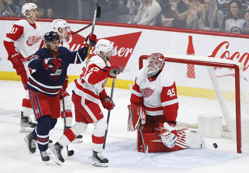 Winnipeg Jets' Nino Niederreiter (62) celebrates after his goal against Detroit Red Wings goaltender Magnus Hellberg (45) during second-period NHL hockey game action in Winnipeg, Manitoba, Friday, March 31, 2023. (John Woods/The Canadian Press via AP)