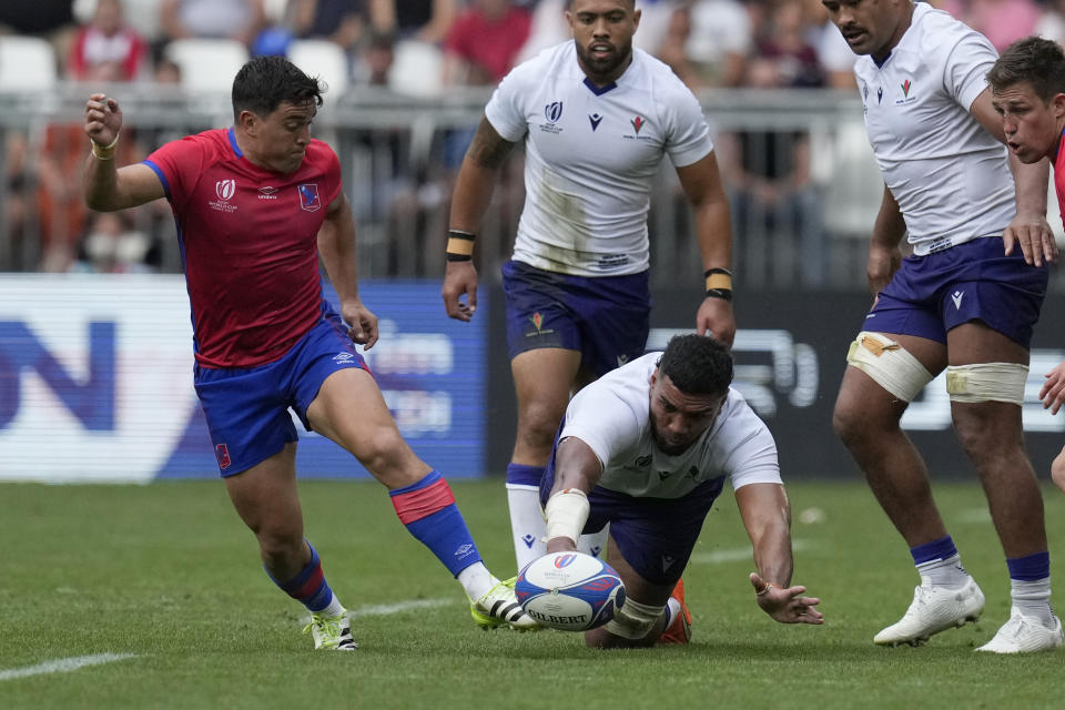 Samoa's Taleni Junior Agaese Seu, bottom, battles for the control of the ball against Chile's Marcelo Torrealba, right, during the Rugby World Cup Pool D match between Samoa and Chile at the Stade de Bordeaux in Bordeaux, France, Saturday, Sept. 16, 2023. (AP Photo/Themba Hadebe)