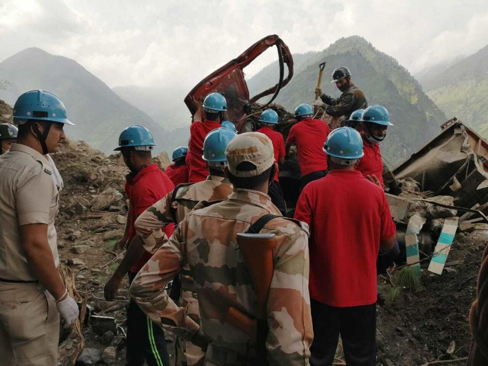 This photograph provided by India's Indo Tibetan Border Police (ITBP) shows a rescue operation at the site of a landslide in Kinnaur district in the northern Indian state of Himachal Pradesh, Wednesday, Aug. 11, 2021. A landslide struck several vehicles traveling on a highway in the hills of northern India on Wednesday, trapping as many as 50 people, officials said. (Indo Tibetan Border Police via AP)