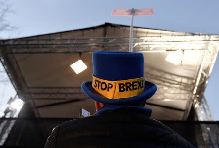 Anti-Brexit protestor Steve Bray is seen at dawn holding a placard in front of a temporary news studio near the Houses of Parliament, in London, Britain, December 10, 2018. REUTERS/Toby Melville