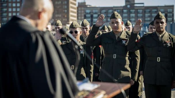 PHOTO: U.S. Marines with 1st Battalion, 8th Marine Regiment, raise their right hand during the Oath of Allegiance aboard the Battleship USS North Carolina Dec. 2, 2022.  (U.S. Marine Corps photo by Lance Cpl. Noah Seal)