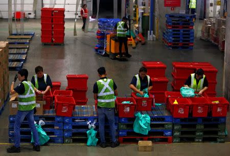 Employees work at RedMart's fulfillment centre in Singapore September 22, 2017. REUTERS/Edgar Su