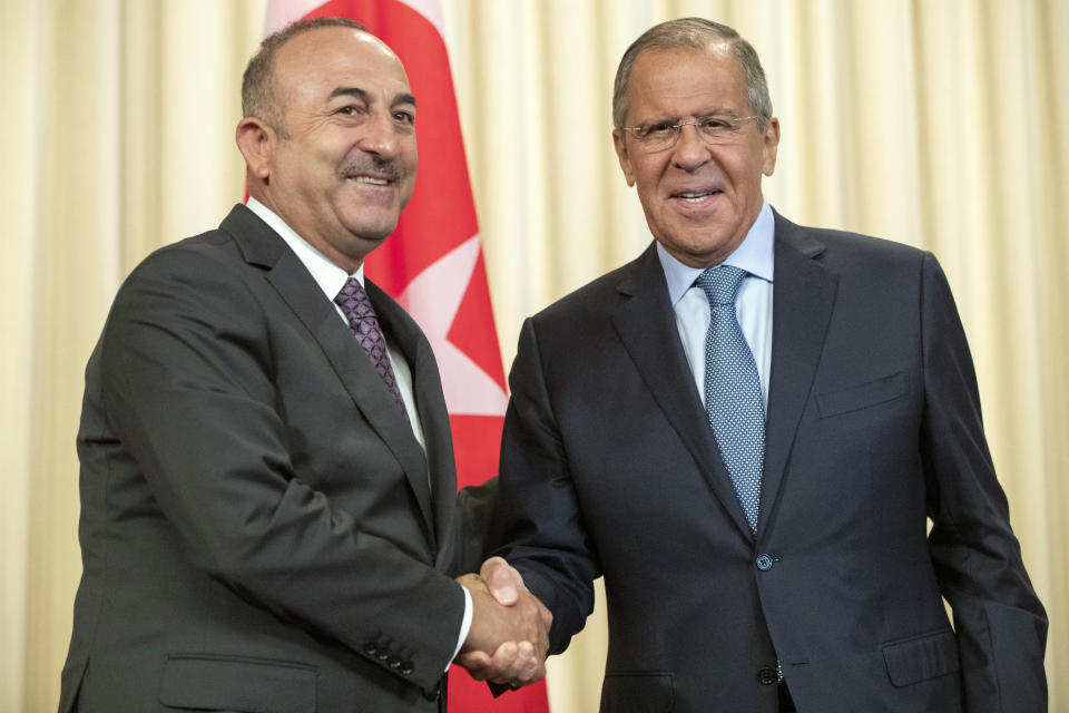 Russian Foreign Minister Sergey Lavrov, right, and his Turkish counterpart Mevlut Cavusoglu shake hands during their meeting in Moscow, Russia, Friday, Aug. 24, 2018. Turkey’s Foreign Minister on Friday warned against a possible Syrian government offensive on the last remaining opposition stronghold while Russia indicated that it’s losing its patience with the rebels. (AP Photo/Pavel Golovkin)