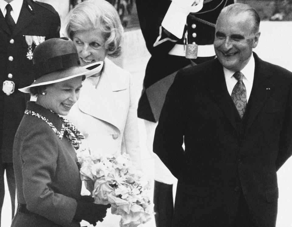 Queen Elizabeth II holding a bouquet of flowers, and French President Georges Pompidou and wife Claude Pompidou pose after a luncheon given in the Queen's honor at the Elysee palace (AP1972)