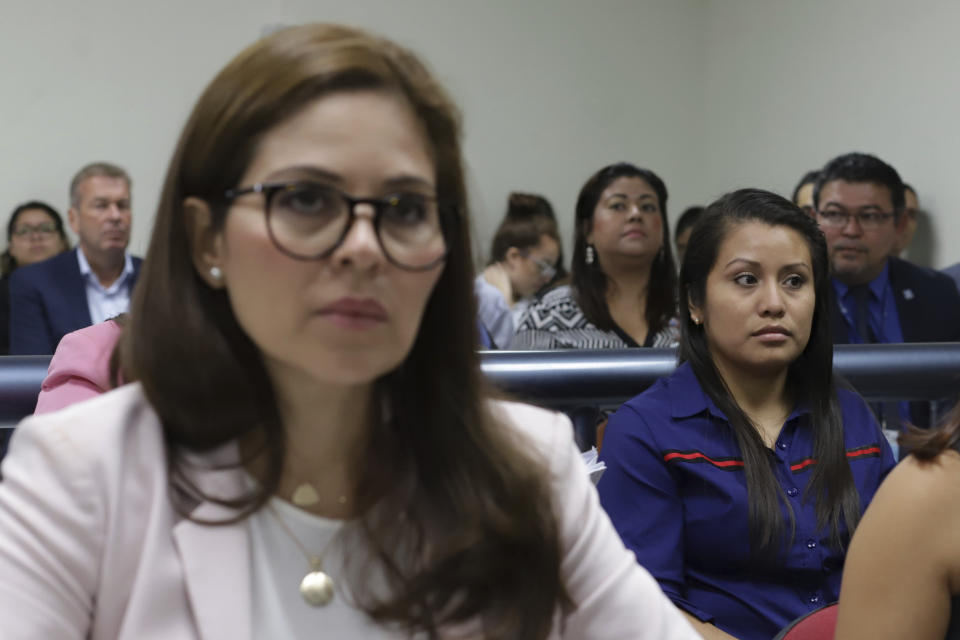 Evelyn Beatriz Hernandez, right, sits in court during her second trial, after her 30-year sentence for abortion was overturned in February, in Ciudad Delgado on the outskirts of San Salvador, El Salvador, Monday, July 15, 2019. The young woman who birthed a baby into a pit latrine in El Salvador faces a second trial for murder Monday in a case that has drawn international attention because of the country's highly restrictive abortion laws. (AP Photo/Salvador Melendez)