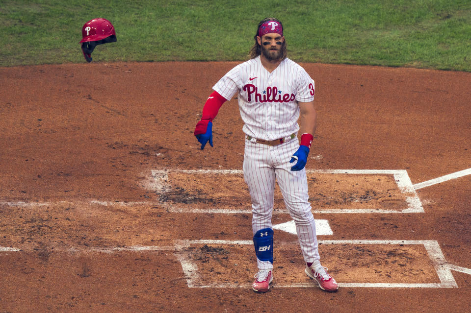 Philadelphia Phillies' Bryce Harper tosses his helmet after striking out during the first inning of a baseball game against the New York Mets, Saturday, Aug. 15, 2020, in Philadelphia. (AP Photo/Chris Szagola)