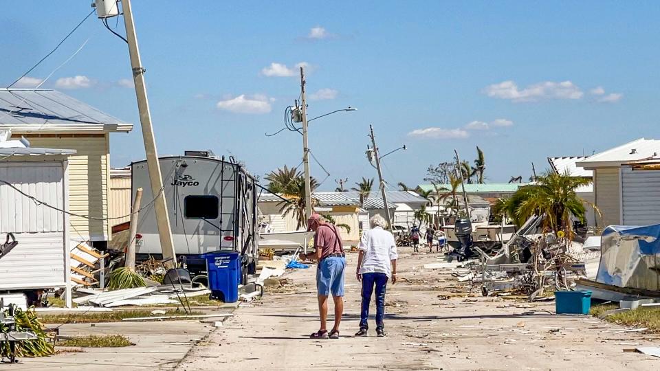 Kiko and Gordie, long time St James City residents, returned to their Pine Island home for the first time since evacuating before Hurricane Ian. They walk down their street to check on their neighbor's houses.  Monday, September 03, 2022. 
