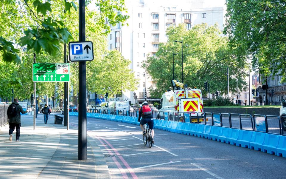 Cyclists use new cycle lanes on Park Lane set up to encourage less use of public transport