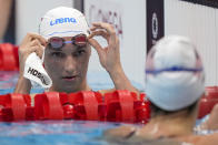 Katinka Hosszu of Hungary removes her goggles following her heat of the women's 200-meter individual medley at the 2020 Summer Olympics, Monday, July 26, 2021, in Tokyo, Japan. (AP Photo/Martin Meissner)