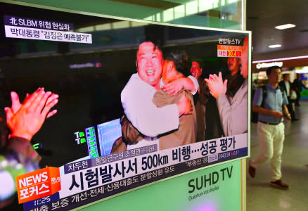 A man walks past a television screen showing North Korean leader Kim Jong-Un celebrating its latest submarine-launched ballistic missile test at a railway station in Seoul on August 25, 2016. North Korean leader Kim Jong-Un declared a recent submarine-launched ballistic missile (SLBM) test the "greatest success", Pyongyang's state media said on August 25. / AFP / JUNG YEON-JE (Photo credit should read JUNG YEON-JE/AFP/Getty Images)