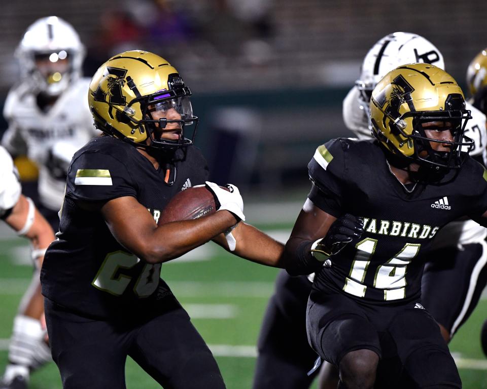 Abilene High running back Antoine Rashaw follows behind wide receiver Tim Outlaw as he carries the ball against Odessa Permian during last season's game at Shotwell Stadium.