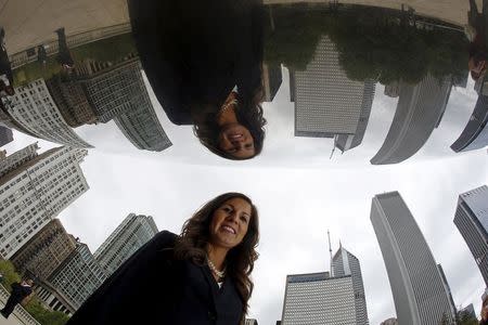 Former Illinois Senate candidate Stefanie Linares, who is a lawyer, is reflected in the Cloud Gate Sculpture as she poses for a photo in Chicago, Illinois, United States, May 12, 2015. REUTERS/Jim Young