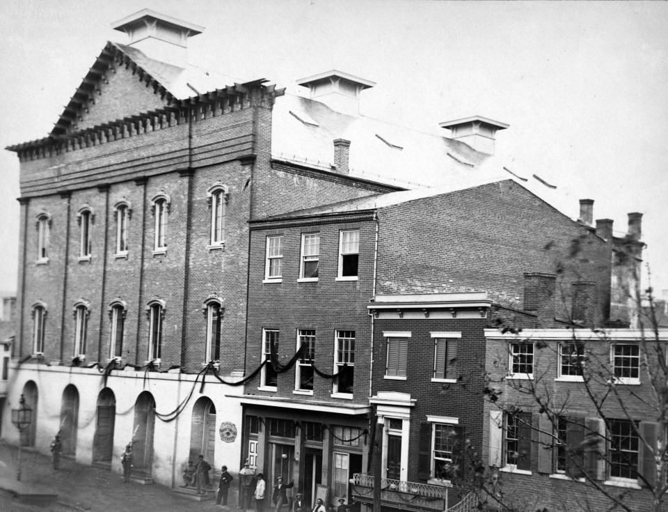 FILE - In this undated photo provided by the Library of Congress shows Ford's Theatre, at left, the scene of the assassination of President Abraham Lincoln, in Washington, D.C., in 1865. Within 16 months of the assassination, the theater was closed and the federal government turned the building into office space, but it became a working theater again in the 1960s and the interior was recreated to show what it looked like the night Lincoln was shot. (AP Photo/Library of Congress)