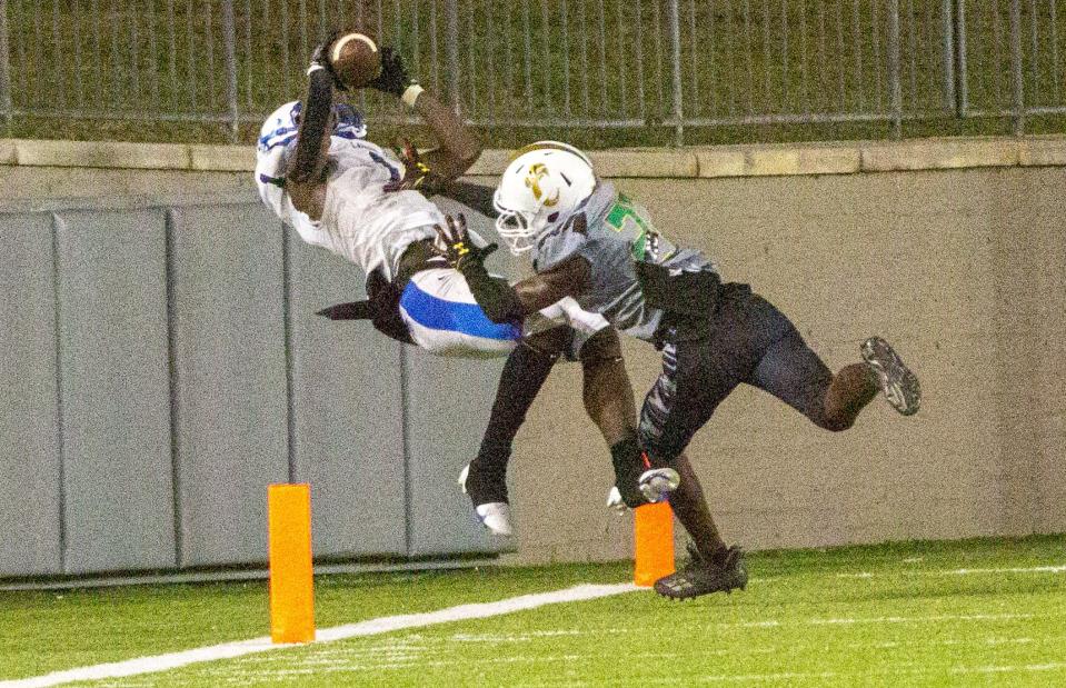 Lanier's Jamarcus Hamilton (1) falls backwards after a catch, securing the Poets the first touchdown of the game against Carver on October 15, 2021.