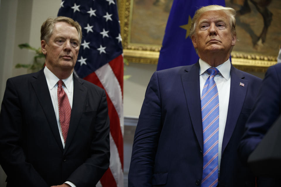 President Donald Trump stands with U.S. Trade Representative Robert Lighthizer during an event about expanding U.S. beef exports to the European Union, in the Roosevelt Room of the White House, Friday, Aug. 2, 2019, in Washington. (AP Photo/Evan Vucci)