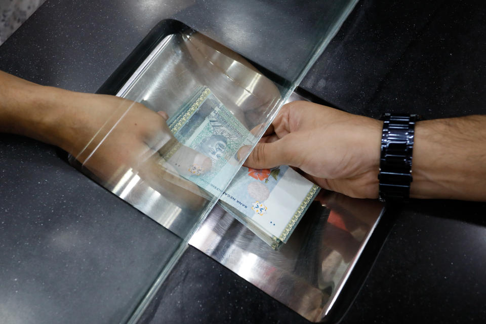 The ringgit is currently trading around 4.7065 per dollar, having strengthened from a 26-year low of 4.8053 set in February. (Photographer: Samsul Said/Bloomberg)