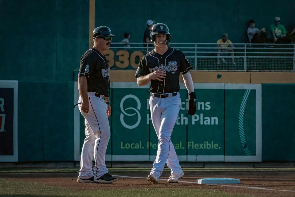 Lansing Lugnuts infielder Cooper Bowman, left, stands next to manager Phil Pohl at third base. Bowman recently joined the Lugnuts after being acquired by the Oakland Athletics in a deal with the New York Yankees.