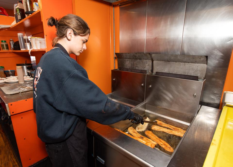 Cyrus Baillargeon fries fresh dough to a perfect, golden brown at Blink's Fry Doe at Hampton Beach. The iconic spot is celebrating its 50th year at Hampton Beach in 2024.