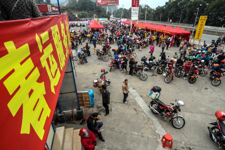 Chinese motorcyclists rest in Wuzhou on January 25, 2014