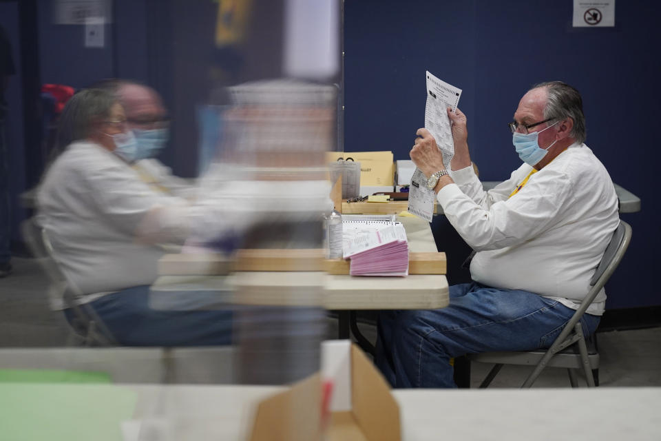 FILE - In this Oct. 31, 2020, county employees process mail-in ballots at a Clark County election department facility in Las Vegas. Nevada's decision to send all active voters mail-in ballots ahead of the November election sprung the western swing state into the center of the nationwide debate over voting procedures in the months leading up to election. (AP Photo/John Locher, File)