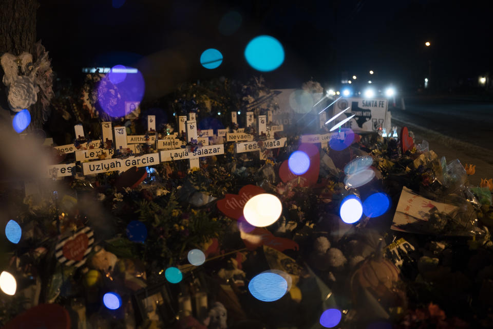 Crosses bearing the names of the victims killed in last week's school shooting are seen through a balloon at a memorial at Robb Elementary School in Uvalde, Texas, Wednesday, June 1, 2022. (AP Photo/Jae C. Hong)