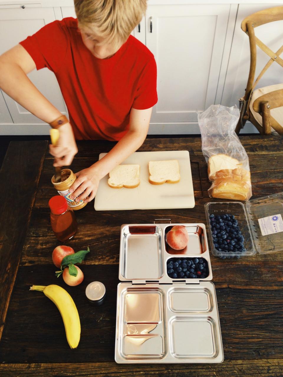 This 2015 image shows Charlie Freilich, son of food writer Katie Workman, preparing his school lunch in New York. If you have a pint-size vegetarian at home, there's no reason that packed lunches for school can't be as nourishing, delicious and kid-friendly as any other. (Katie Workman via AP)