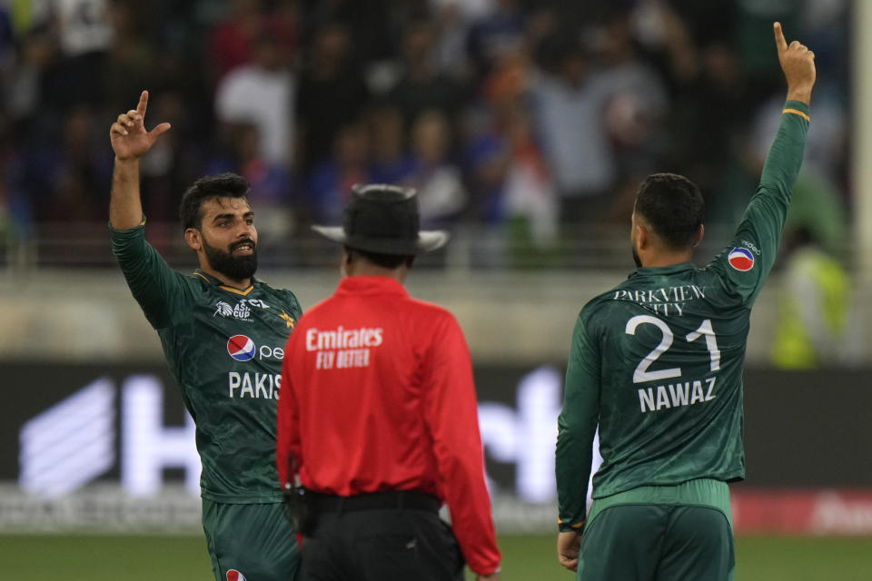 Pakistan's Mohammad Nawaz, right, celebrates with teammate Shadab Khan, left, after the dismissal of India's Suryakumar Yadav during the T20 cricket match of Asia Cup between India and Pakistan, in Dubai, United Arab Emirates, Sunday, Sept. 4, 2022. (AP Photo/Anjum Naveed)