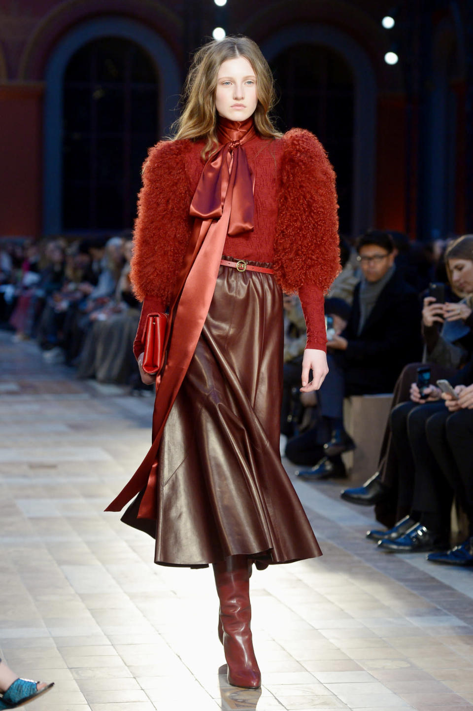 A model shows off a fur-sleeve sweater and leather skirt during the fall 2016 Sonia Rykiel show in Paris.