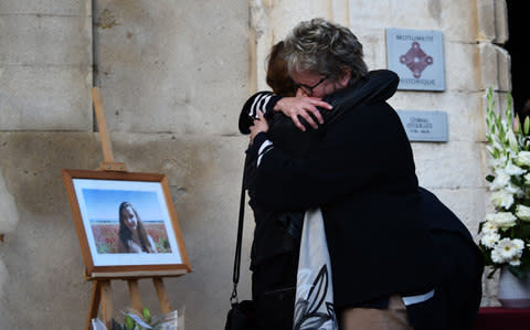 Relatives of the victim Mauranne take part in a tribute next to her portrait, on October 2, 2017, in Eguilles, southern France, the day after Mauranne and Laura, two 20-year-old cousins, were killed outside Saint-Charles train station in Marseille - Credit: ANNE-CHRISTINE POUJOULAT/AFP
