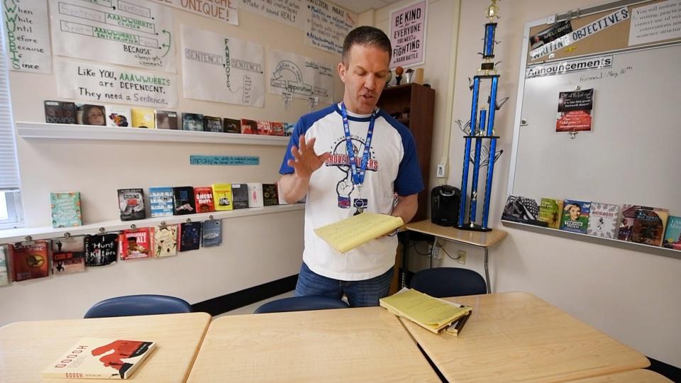 Seth McLane describes how his writing process begins with notes on a yellow pad while standing in his classroom at the Spring Grove Middle School on April 11, 2024.