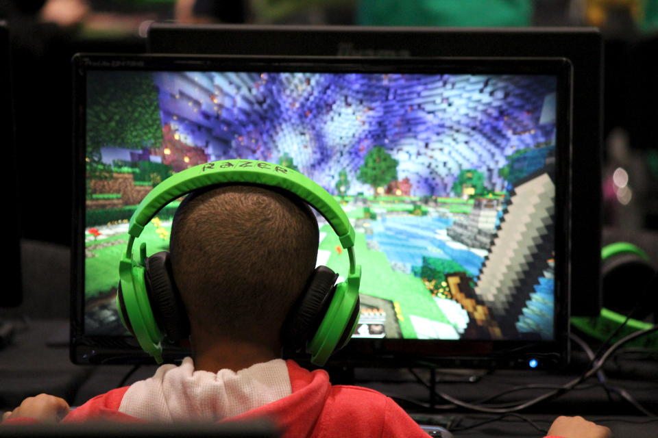 A child plays video game Minecraft at the Minecon convention in London July 4, 2015. The 10,000 tickets sold for Minecon in London made it the largest ever convention for a single video game. REUTERS/Matthew Tostevin