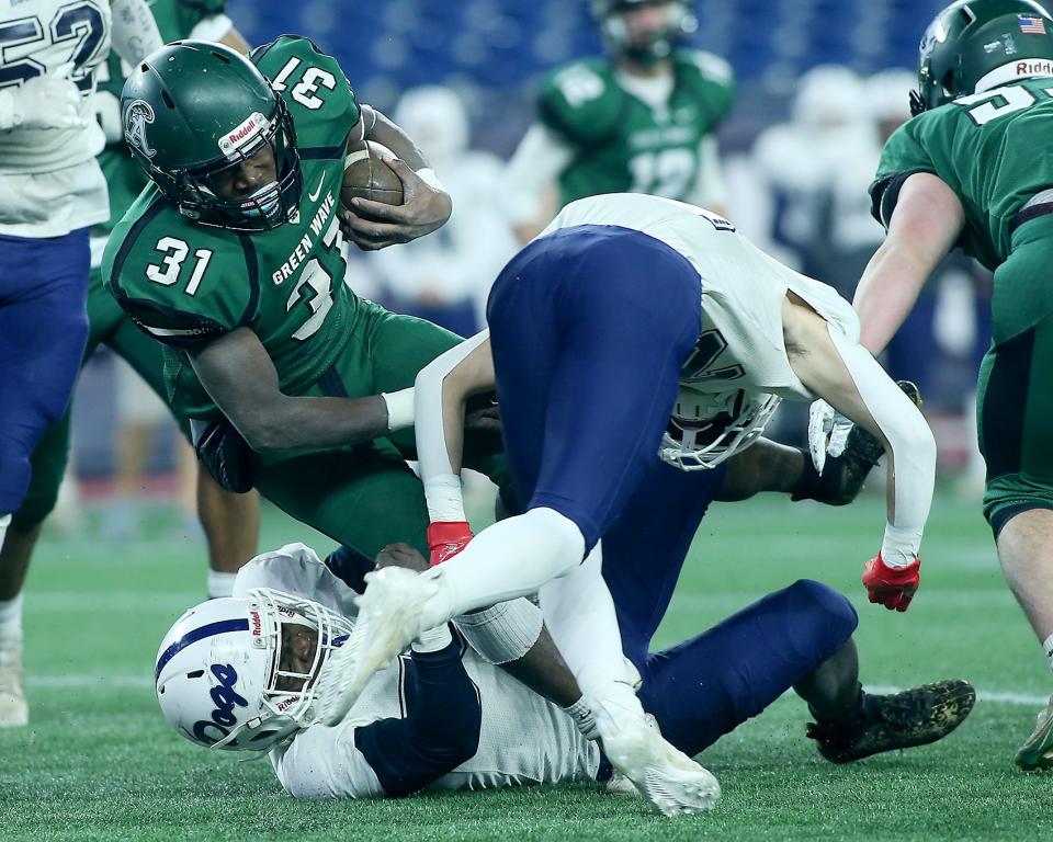 Abington’s Kurtis Lucas-Summers tries to escape the tackle of Rockland’s Austin Clarke during second quarter action of the Division 6 state title game at Gillette Stadium on Friday, Dec. 3, 2021.