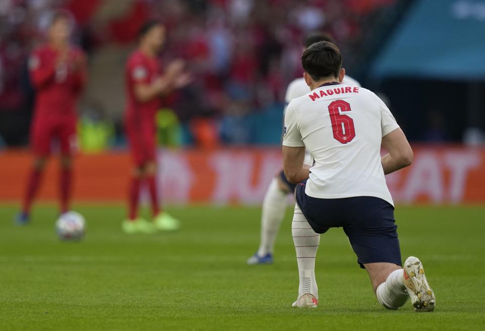 England&#39;s defender Harry Maguire takes a knee before the start of the UEFA EURO 2020 semi-final football match between England and Denmark at Wembley Stadium in London on July 7, 2021. (Photo by Frank Augstein / POOL / AFP) (Photo by FRANK AUGSTEIN/POOL/AFP via Getty Images)